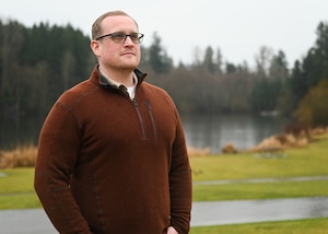 U.S. Air Force Master Sgt. Alexander Northrup, first sergeant for the 313th Airlift Squadron and a human resource development specialist with the Department of the Army, poses for a photo at Bradley Lake Park, Puyallup, Washington, Feb. 21, 2025. Northrup was highlighted for his service in both the military and civilian sectors.