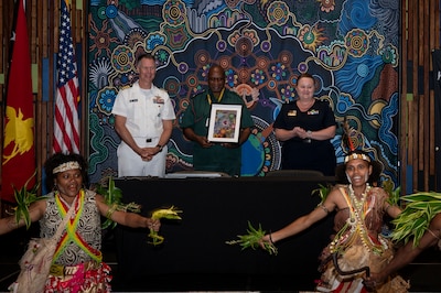 U.S. Navy Capt. Peter Roberts, U.S. Indo-Pacific Command Command Surgeon, and Royal Australian Air Force Air Commodore Nicole dos Santos, RAAF Director General Operational Health and Air Force Health Service, gives Papua New Guinea Defence Force Lt. Col Peter Kaminiel, PNGDF Director General, a gift at the Indo-Pacific health security alliance in Port Moresby, Papua New Guinea, May 8, 2025. IPhsa aims to foster partnerships, counter harmful influences and enhance readiness, contributing to stability, prosperity and a free and open Indo-Pacific. (U.S. Army Photo by Sgt. Austin Riel)