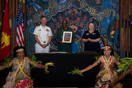U.S. Navy Capt. Peter Roberts, U.S. Indo-Pacific Command Command Surgeon, and Royal Australian Air Force Air Commodore Nicole dos Santos, RAAF Director General Operational Health and Air Force Health Service, gives Papua New Guinea Defence Force Lt. Col Peter Kaminiel, PNGDF Director General, a gift at the Indo-Pacific health security alliance in Port Moresby, Papua New Guinea, May 8, 2025. IPhsa aims to foster partnerships, counter harmful influences and enhance readiness, contributing to stability, prosperity and a free and open Indo-Pacific. (U.S. Army Photo by Sgt. Austin Riel)