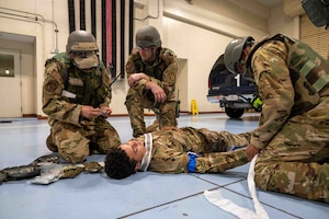 Service members unwraps medical gauze