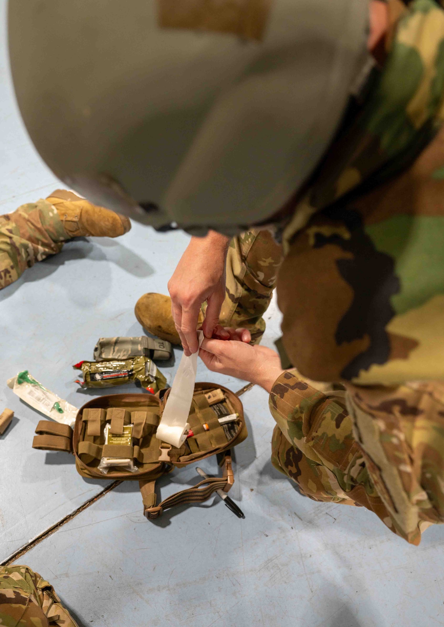 Service members unwraps medical gauze