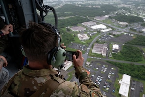 An EOD Airman scanning the airfield from a helicopter