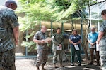 Navy Chaplain Commander Philip Park, second from left, reads a scripture passage during a Blessing of the Hands ceremony held at Naval Health Clinic Cherry Point on Wednesday, May 7.  The spiritual fitness event honored the compassion and professionalism of the nursing staff serving in the facility while fortifying their spiritual resolve.