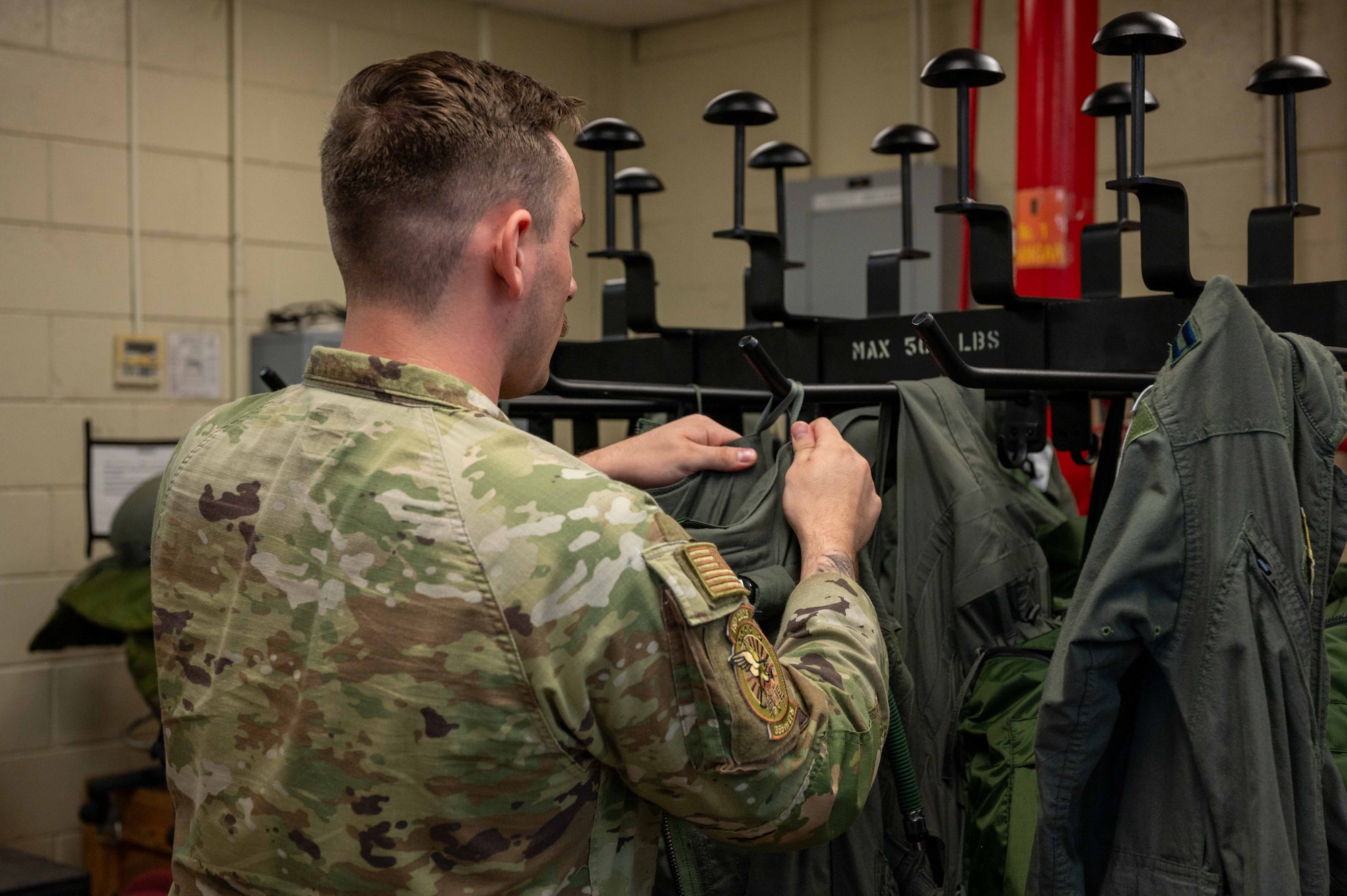 Airman preparing flight suits for use