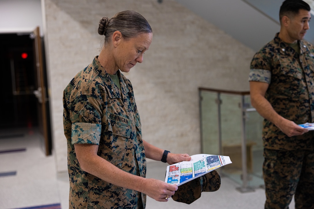 U.S. Marine Corps Brig. Gen. Maura M. Hennigan, commanding general, 2nd Marine Logistics Group (MLG), reads a building layout during a tour of the future 2nd MLG Headquarters building on Marine Corps Base Camp Lejeune, North Carolina, Sept. 18, 2024. Construction of the 2nd MLG Headquarters building is the result of a comprehensive infrastructure reset evaluation that took place in 2017. The new headquarters will encompass nearly 36,000 square feet and provide administrative and support functions necessary to provide combat logistics operations in support of II Marine Expeditionary Force and is expected to be completed in early 2025. (U.S. Marine Corps photo by Cpl. Loriann Dauscher)