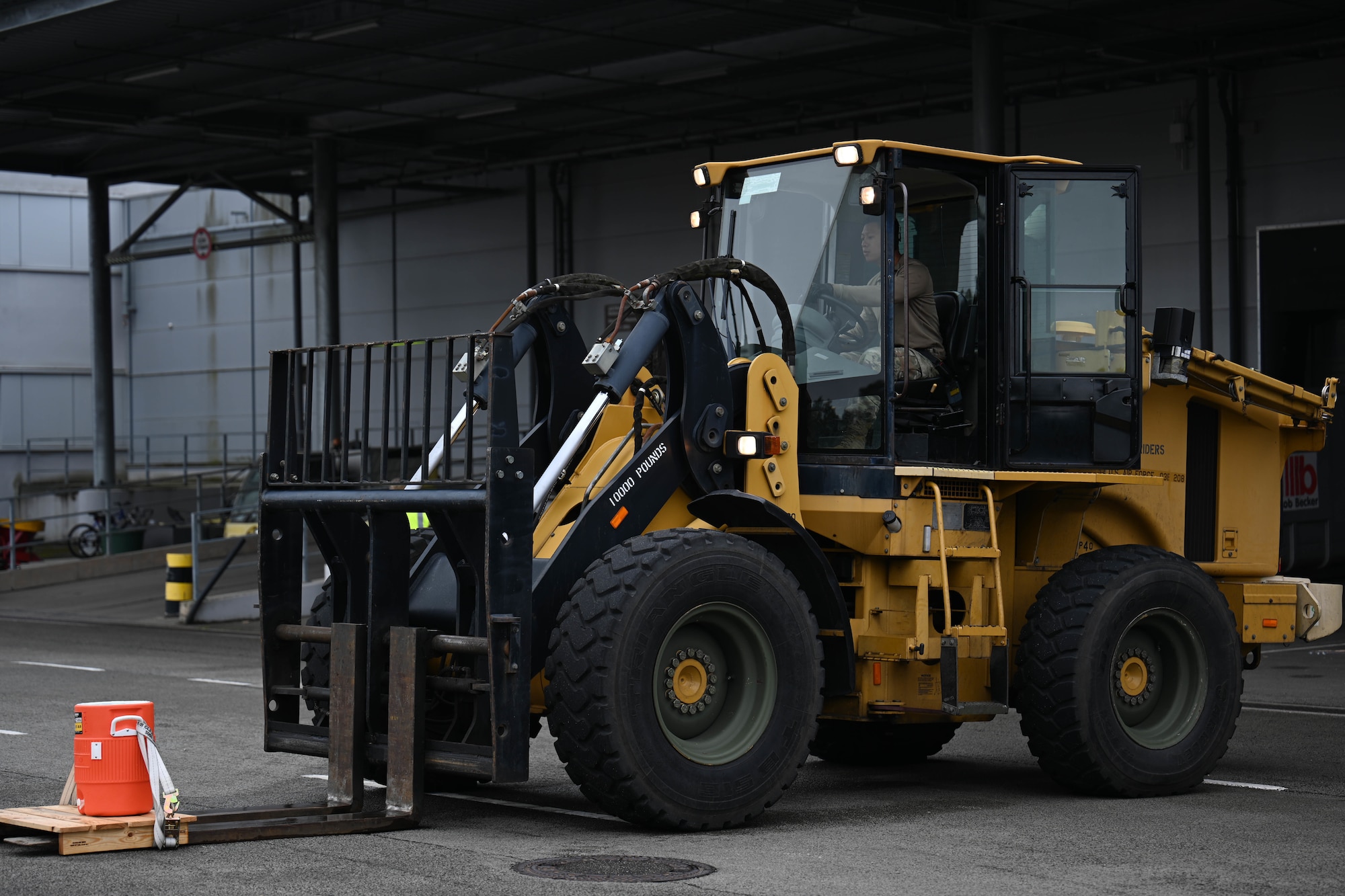 A U.S. Air Force member assigned to the 60th Aerial Port Squadron, from Travis Air Force Base, Calif., drives a 10K forklift for an obstacle course during the 521st Air Mobility Operations Wing Mobility Vanguard 2025 at Ramstein Air Base, Germany, May 24, 2025.