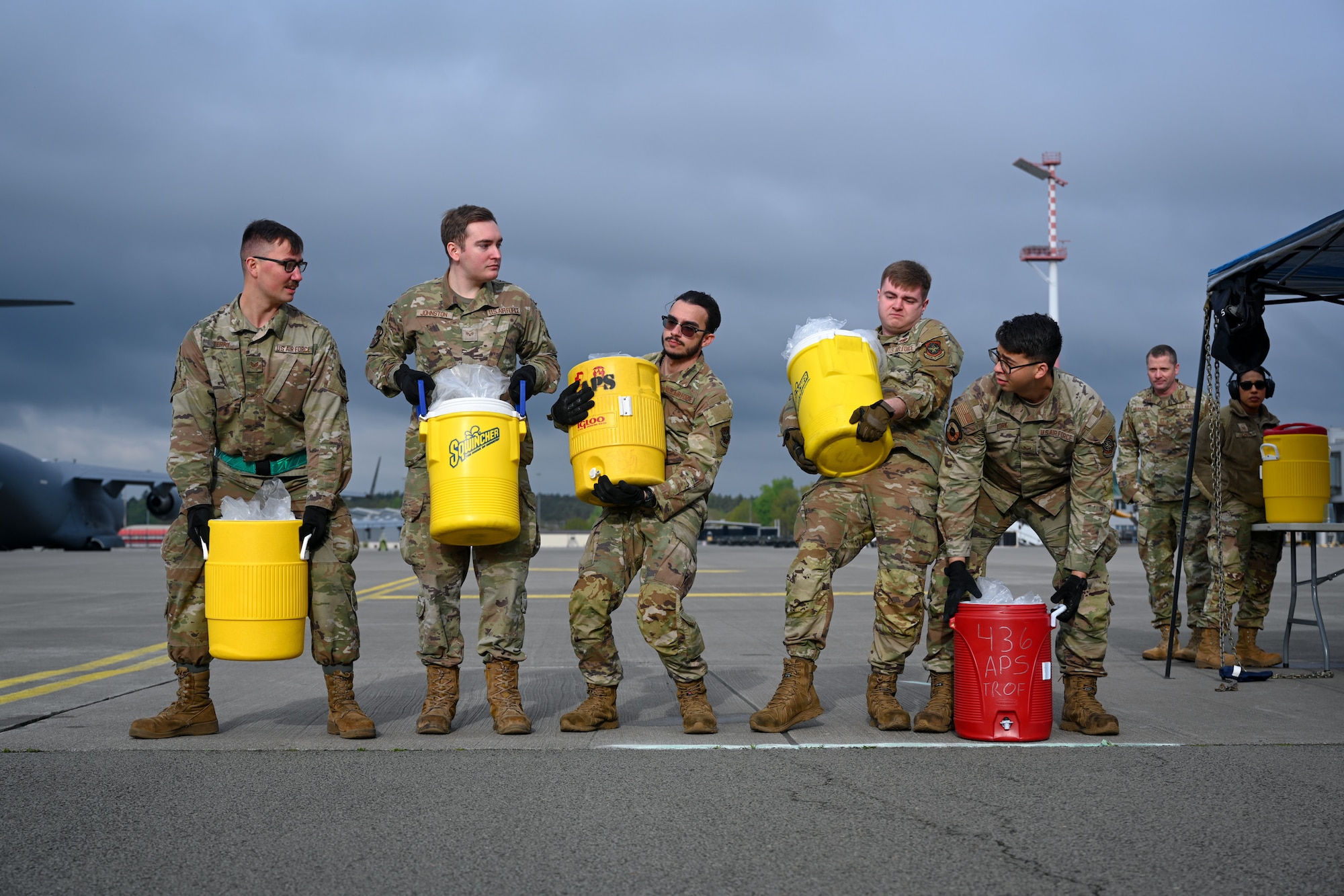U.S. Air Force members assigned to the 721st Aircraft Maintenance Squadron from Ramstein Air Base, Germany, prepare to begin the Combat Fitness Challenge during the 521st Air Mobility Operations Wing Mobility Vanguard 2025 at Ramstein AB, May 25, 2025.