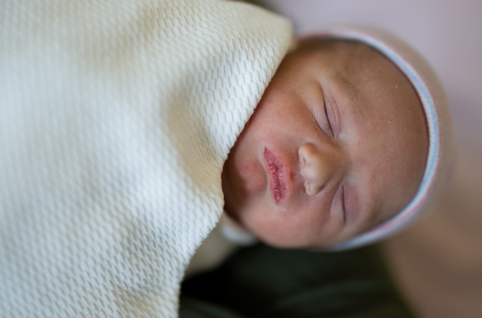 Reign Cole Wisinger, the first baby born at the new Roosevelt Pavilion at Walter Reed National Military Medical Center in Bethesda, Md., on May 4, rests peacefully in his mother’s arms. The new facility offers military families state-of-the-art services and a comfortable, family-centered environment. (DOD photo by Ricardo J. Reyes)