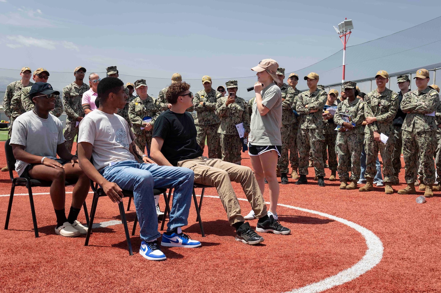 Sailors assigned to Naval Support Activity Souda Bay  perform a skit about safe drinking habits as part of the Coalition of Sailors Against Destructive Decision during a Summer Safety Stand Down event hosted by the NSA Souda Bay Safety Office at the base softball field on May 6, 2025.