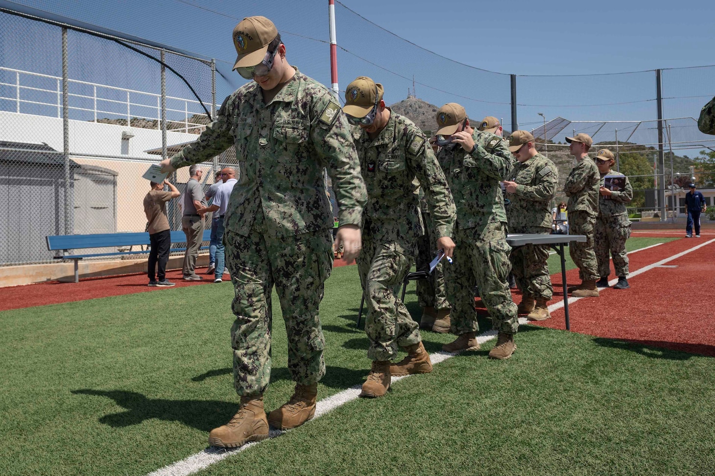 Sailors assigned to Naval Support Activity Souda Bay use simulation drunk goggles during a Summer Safety Stand Down event hosted by the NSA Souda Bay Safety Office at the base softball field on May 6, 2025.