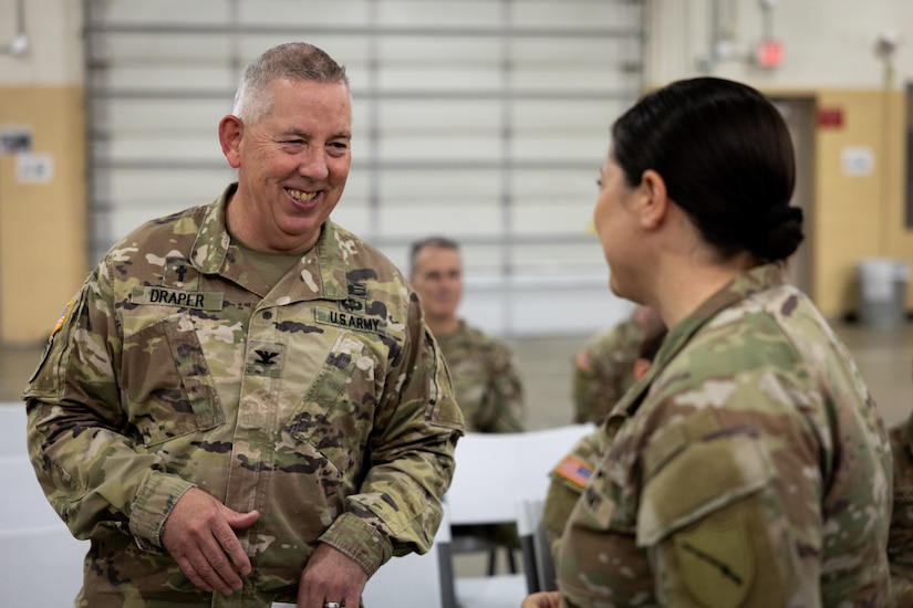 Chap. (Lt. Col.) Bill Draper chats with Chief Warrant Officer 5 Jennifer Ritchie, state command chief warrant officer, at the Kentucky National Day of Prayer event at the Wellman Armory in Frankfort, Ky. on May 1, 2025. The Kentucky National Guard held its 15th annual National Day of Prayer for service members, civilians, fallen warriors and their families at a breakfast ceremony. (U.S. Army National Guard photo by Andy Dickson)