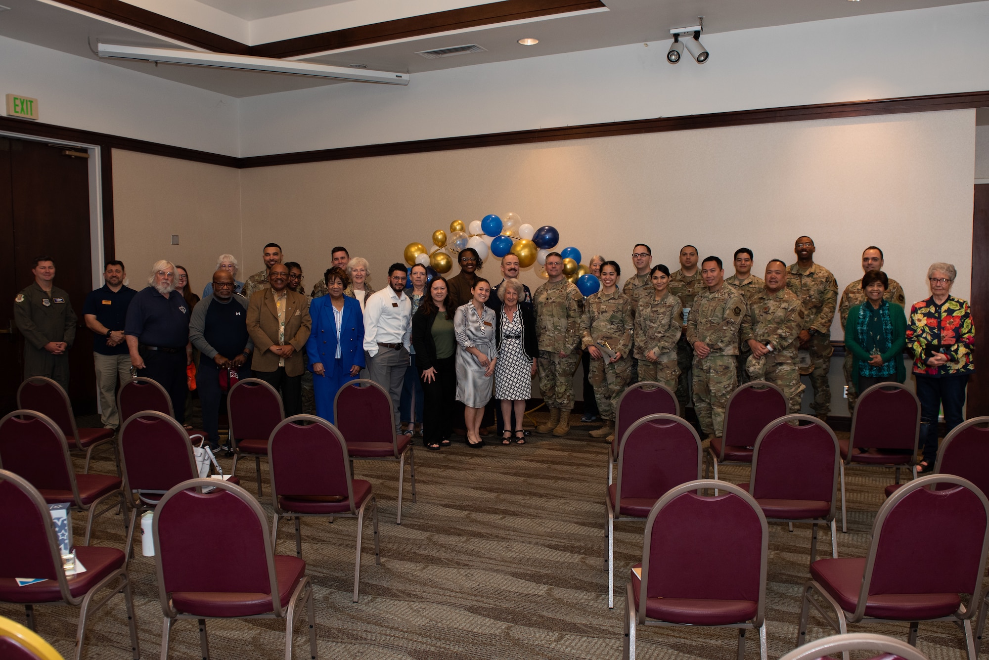 Volunteers, family and leadership pose for a group photo
