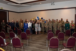 Volunteers, family and leadership pose for a group photo