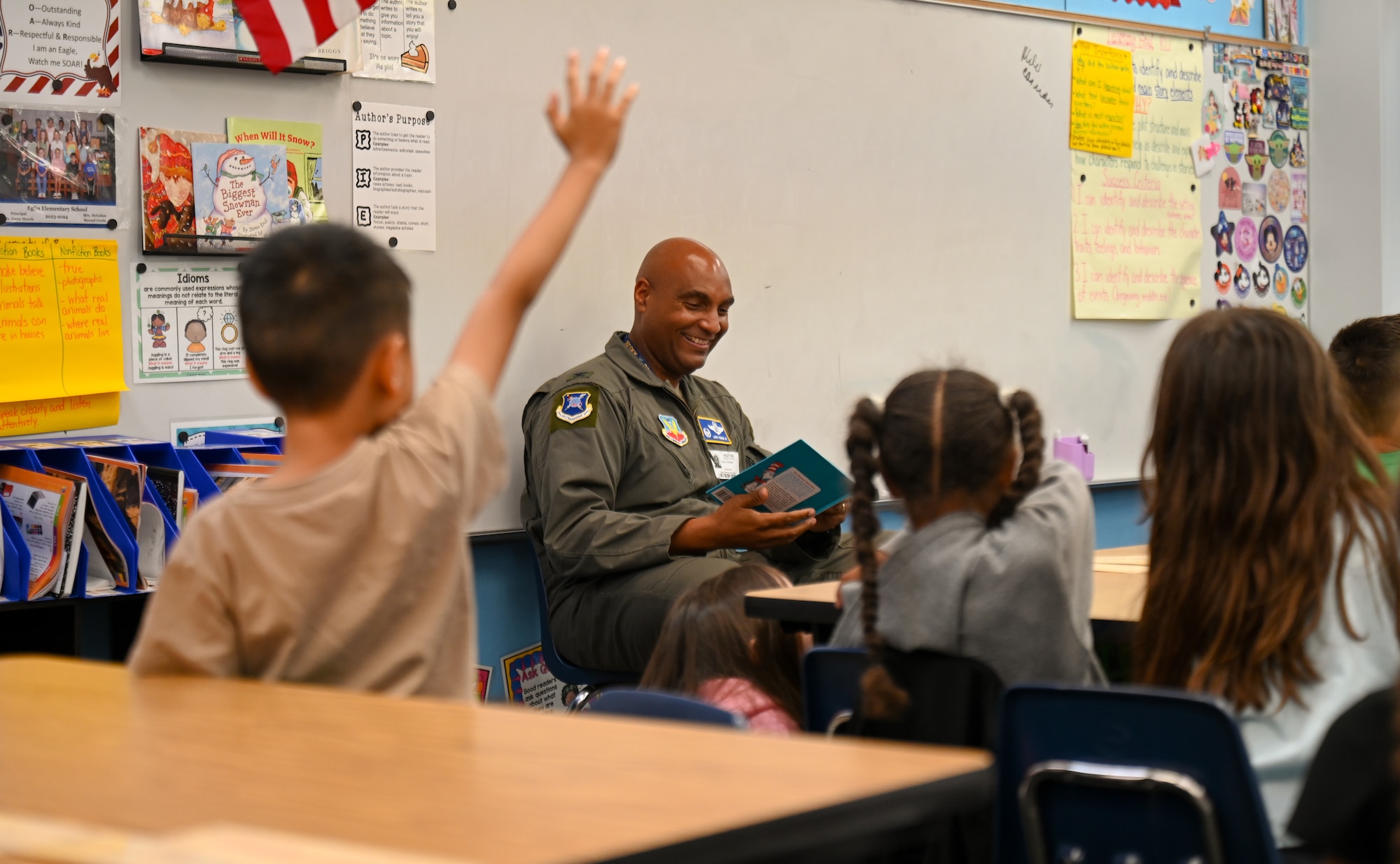U.S. Air Force Col. Larry Fenner Jr., 350th Spectrum Warfare Wing commander, reads and answers questions from 2nd graders at Eglin Elementary School during Month of the Military Child at Eglin Air Force Base, Florida, April 28, 2025. The Month of the Military Child recognizes the strength and resilience of military children, who grow up facing distinct challenges as their parents uphold the demanding duties of military service. (U.S. Air Force photo by Capt. Benjamin Aronson)