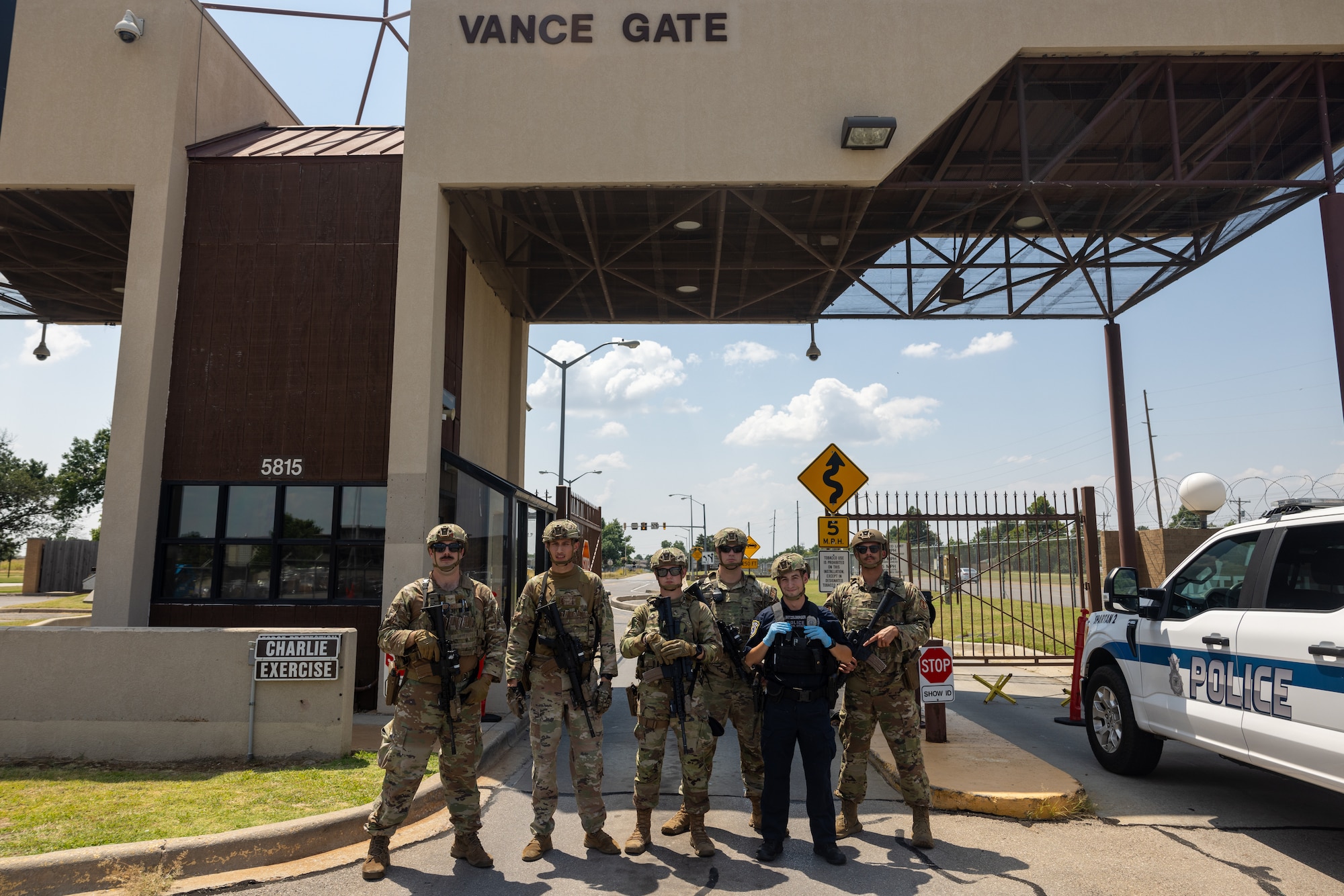 cops stand in front of a base gate