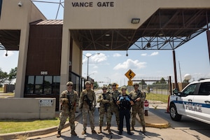 cops stand in front of a base gate