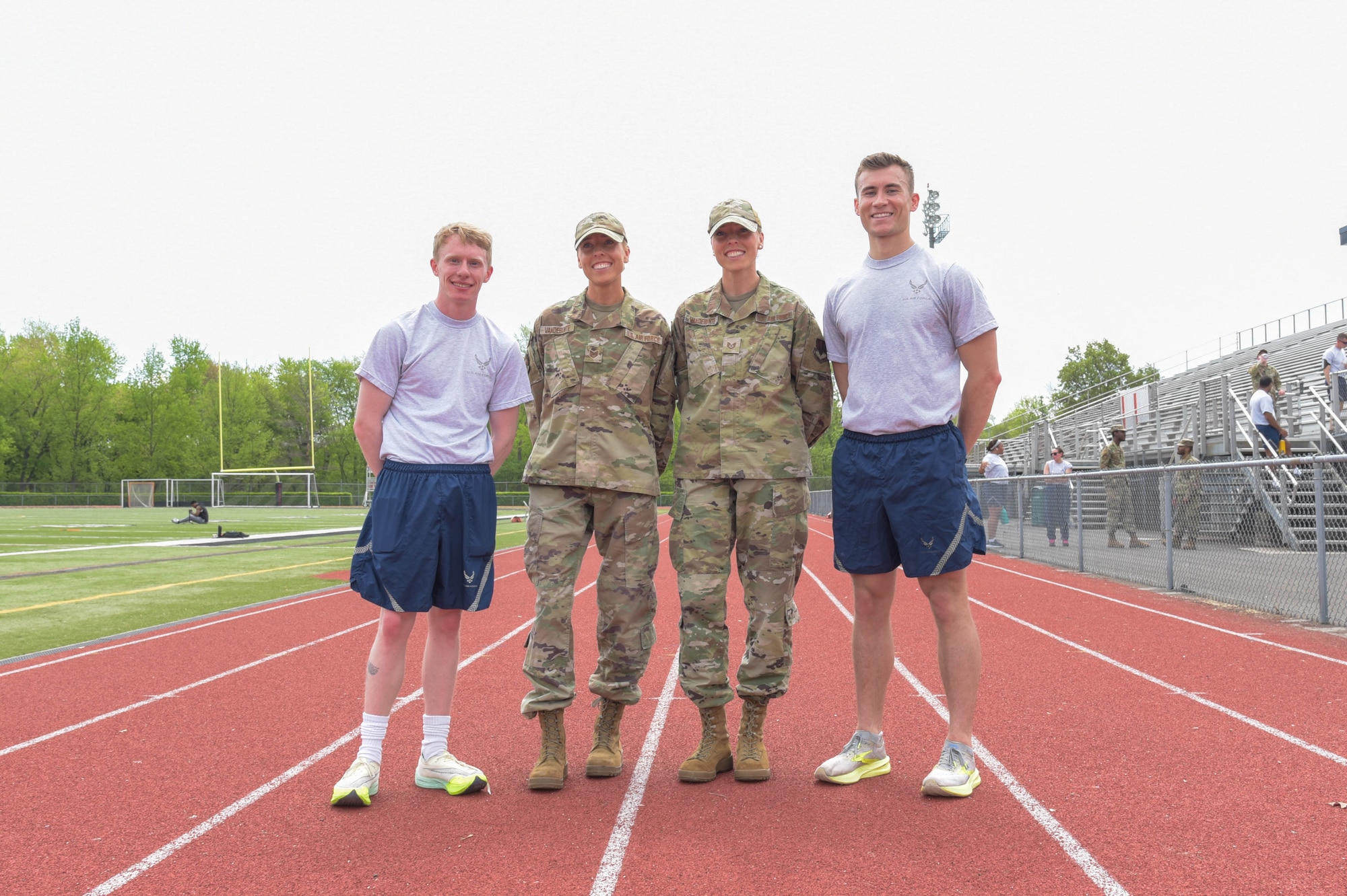 From left, Airman 1st Class Noah Lockie, 270th Engineering Installation Squadron radar airfield and weather systems, Tech. Sgt. Alissa VandeBunte, 270th Engineering Installation Squadron engineering, her twin sister Tech. Sgt. Brianna VandeBunte, 111th Force Support Squadron, and Staff Sgt. Bryce Gable, 270EIS cable antenna systems, pose for a photo during their annual PT test on Saturday, May 3, 2025, at the track at Hatboro-Horsham High School in Horsham, Pennsylvania.