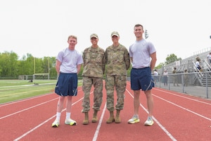 From left, Airman 1st Class Noah Lockie, 270th Engineering Installation Squadron radar airfield and weather systems, Tech. Sgt. Alissa VandeBunte, 270th Engineering Installation Squadron engineering, her twin sister Tech. Sgt. Brianna VandeBunte, 111th Force Support Squadron, and Staff Sgt. Bryce Gable, 270EIS cable antenna systems, pose for a photo during their annual PT test on Saturday, May 3, 2025, at the track at Hatboro-Horsham High School in Horsham, Pennsylvania.