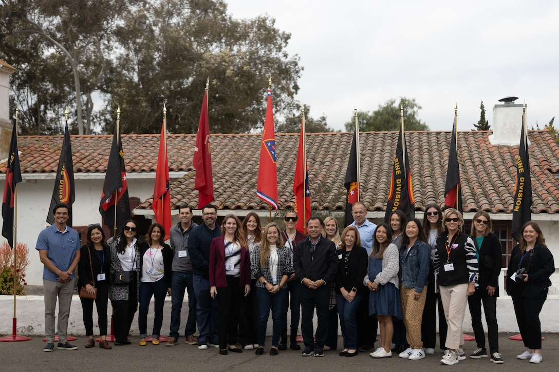 Attendees of the Experience Camp Pendleton Tour gather for a group photo at the Santa Margarita Ranch House, Marine Corps Base Camp Pendleton, Calif., May 1, 2025. The tour offered a glimpse into the base's history, including stops at the Las Flores Adobe, Marine Mechanized Museum, and WWII/Korea LVT Museum. Participants gain insights into the evolution of Marine Corps operations and the cultural heritage preserved within the base. (U.S. Marine Corps photo by Sgt. Patrick King)