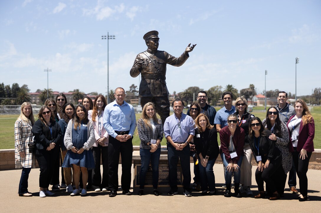 Attendees of the Experience Camp Pendleton Tour gather for a group photo at the Maj. Gen Joesph Pendleton Statue, Marine Corps Base Camp Pendleton, Calif., May 1, 2025. The tour offered a glimpse into the base's history, including stops at the Las Flores Adobe, Marine Mechanized Museum, and WWII/Korea LVT Museum. Participants gain insights into the evolution of Marine Corps operations and the cultural heritage preserved within the base. (U.S. Marine Corps photo by Sgt. Patrick King)