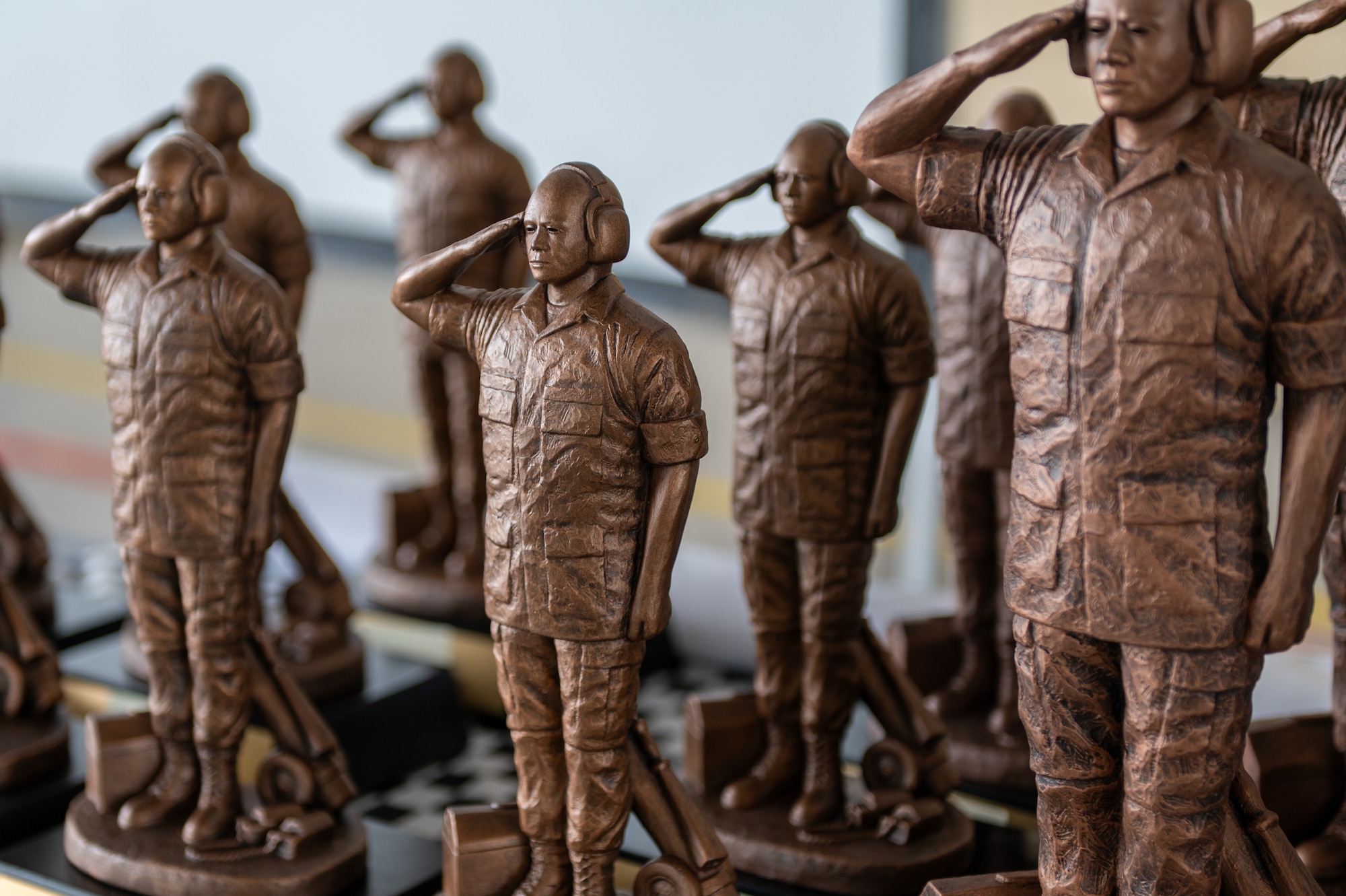 Rows of bronze statues that look like saluting maintenance workers.