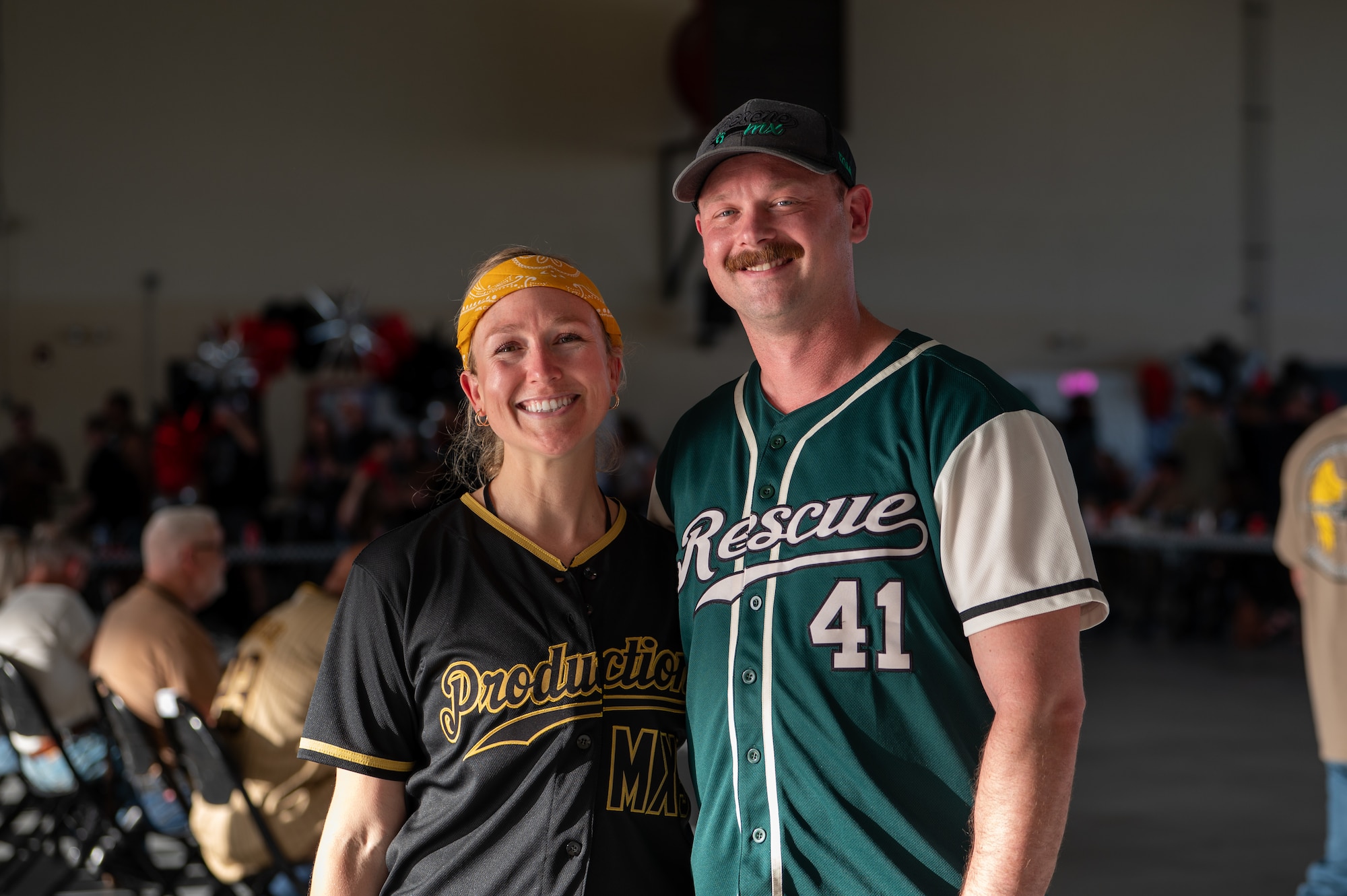 A man and woman smile and pose for a photo.