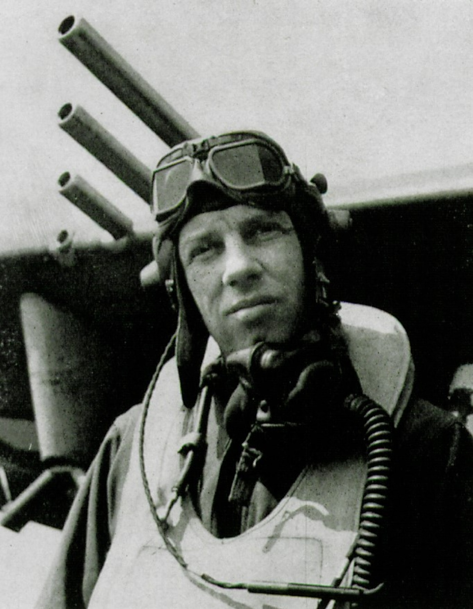 Colonel Bingham T. “Bing” Kleine commanded the 371st Fighter Group during World War II.  He is seen here in flying gear, including a “Mae West” life preserver vest and Royal Air Force MK VIII flying goggles, near the wing of a P-47 Thunderbolt fighter, with the barrels for four .50-caliber machine guns and the underwing pylon for external stores showing prominently.  (The Story of the 371st Fighter Group in the ETO)