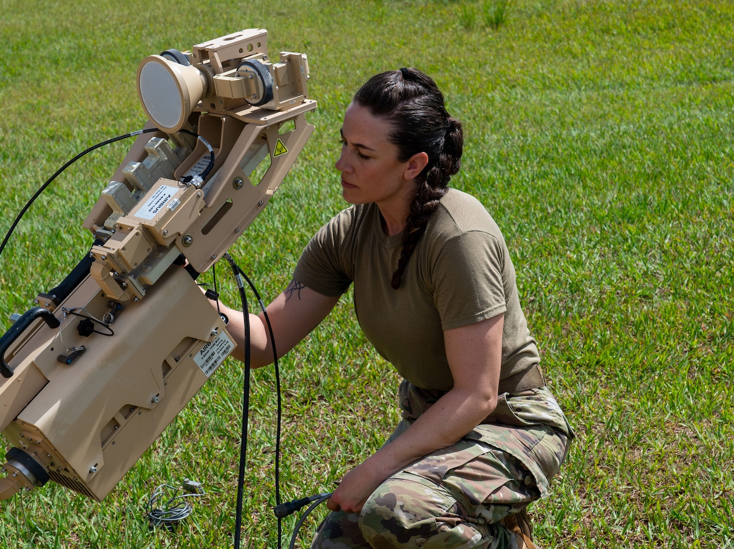 U.S. Air National Guard Technical Sgt. Kelsey Towle, a Radio Frequency Transmission Systems Technician with the 265th Combat Communications Squadon, prepares an antennae to establish communications on April 28th, 2025, at Aguadilla, Puerto Rico.