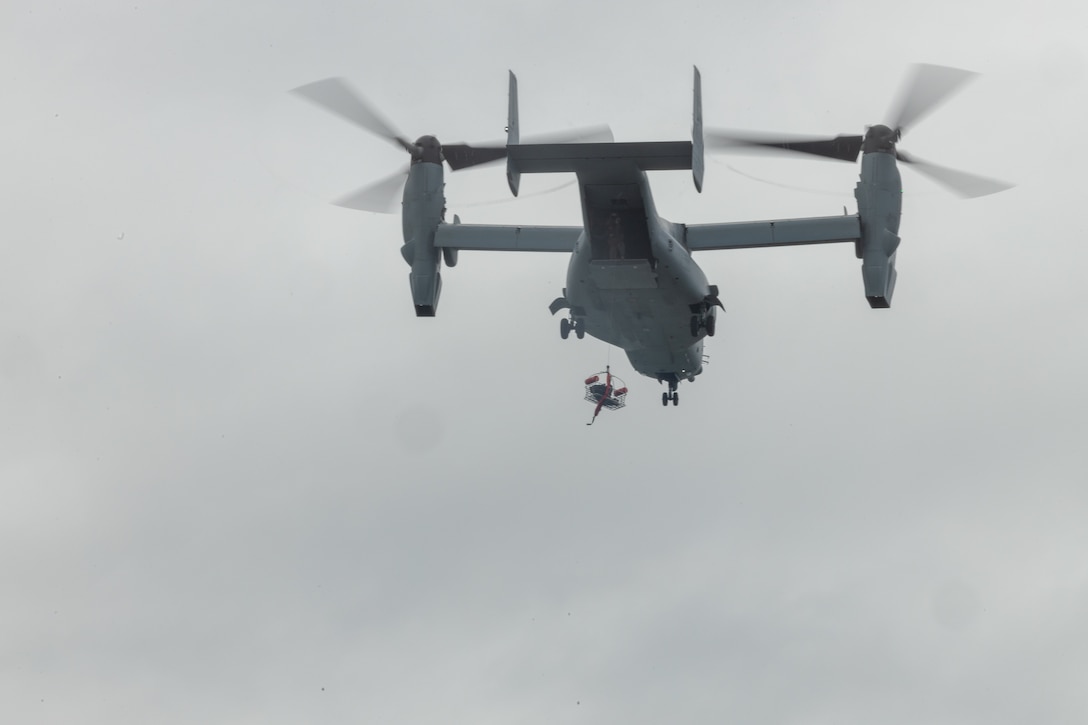 U.S. Marines with Marine Medium Tiltrotor Squadron (VMM) 163 lower a rescue basket from an MV-22 Osprey during a maritime tactical recovery of aircraft and personnel course at Marine Corps Base Camp Pendleton, California, May 5, 2025. The Amphibious Raids Branch, Expeditionary Operations Training Group, conducted the waterborne TRAP operation to develop and standardize procedures for hoist operations in a maritime environment while utilizing the MV-22 Osprey and U.S. Navy rescue swimmers. (U.S. Marine Corps photo by Lance Cpl. Jordan Searls)