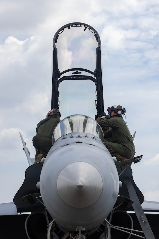 U.S. Marines with Marine Fighter Attack Squadron 323, Marine Aircraft Group 11, 3rd Marine Aircraft Wing, conduct routine maintenance on an F/A-18D Hornet assigned to VMFA 323, Marine Aircraft Group 11, 3rd MAW, in support of Exercise Balikatan 25, at Clark Air Base, Philippines, May 5, 2025. Balikatan is a longstanding annual exercise between the U.S. and Philippine armed forces designed to strengthen the alliance, showcase the capable combined force, and demonstrate the commitment to regional security and stability. (U.S. Marine Corps photo by Lance Cpl. Erica S. Padgett)