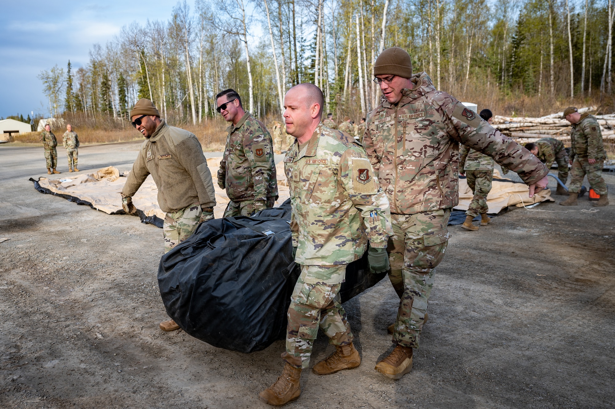 U.S. Air Force first sergeants set up tents at Camp Madbull during the first-ever Pacific Air Forces First Sergeant Readiness Summit on Joint Base Elmendorf-Richardson, Alaska, May 6, 20251. The summit brought more than 100 first sergeants from various major commands to put first sergeant responsibilities into action and improve their combat readiness. (U.S. Air Force photo by Airman 1st Class Hunter Hites)