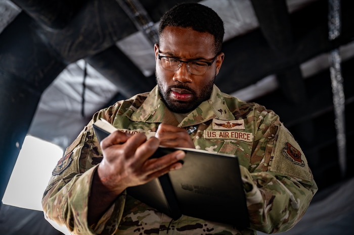 U.S. Air Force Master Sgt. Darius Gamble, a first sergeant assigned to the 1st Special Operations Wing from Hurlburt Field, Fla., takes notes at Camp Madbull during the first-ever Pacific Air Forces First Sergeant Readiness Summit at Joint Base Elmendorf-Richardson, Alaska, May 6. The summit brought more than 100 first sergeants from various major commands to put first sergeant responsibilities into action and improve their combat readiness. (U.S. Air Force photo by Airman 1st Class Hunter Hites)