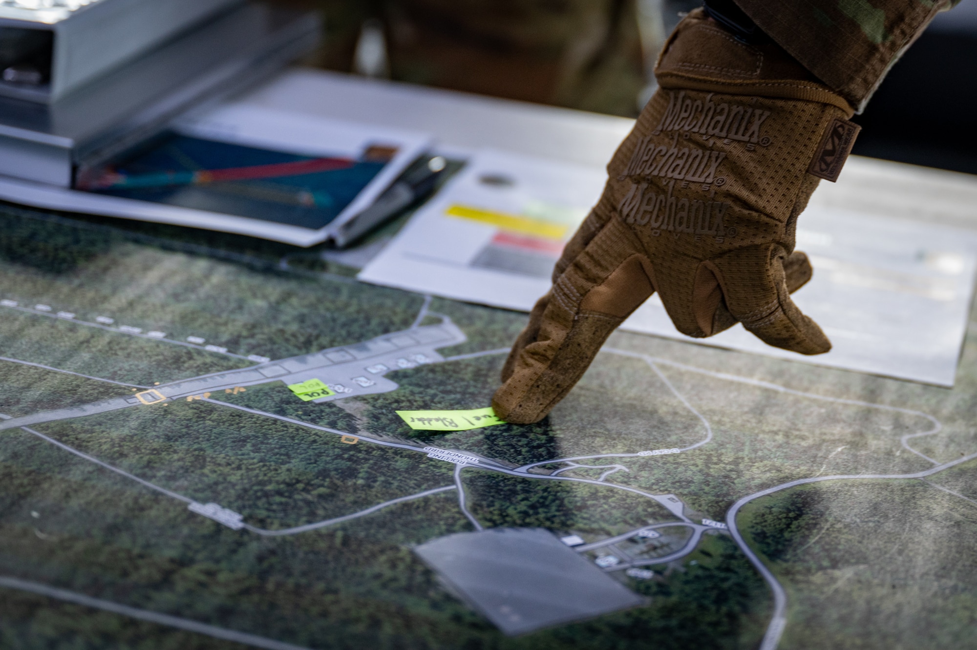 The command team plots activities on a map during the first-ever Pacific Air Forces First Sergeant Readiness Summit at Joint Base Elmendorf-Richardson, Alaska, May 6. The summit brought more than 100 first sergeants from various major commands to put first sergeant responsibilities into action and improve their combat readiness. (U.S. Air Force photo by Airman 1st Class Hunter Hites)