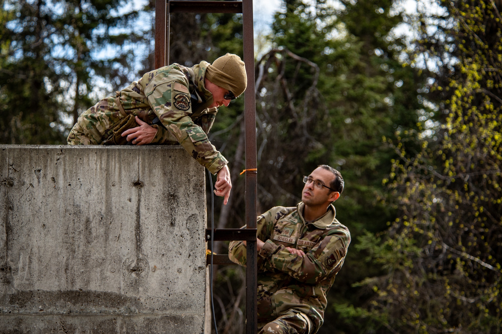 U.S. Air Force Master Sgt. Samuel Weaver (left), a first sergeant assigned to the 734 Air Mobility Squadron from Andersen Air Force Base, Guam, and Master Sgt. Isaac Schooler (right), a first sergeant assigned to the 18th Security Forces Squadron from Kadena Air Base, Japan, set up communications equipment at Camp Madbull during the first-ever Pacific Air Forces First Sergeant Readiness Summit on Joint Base Elmendorf-Richardson, Alaska, May 6, 20251. The summit brought more than 100 first sergeants from various major commands to put first sergeant responsibilities into action and improve their combat readiness. (U.S. Air Force photo by Airman 1st Class Hunter Hites)
