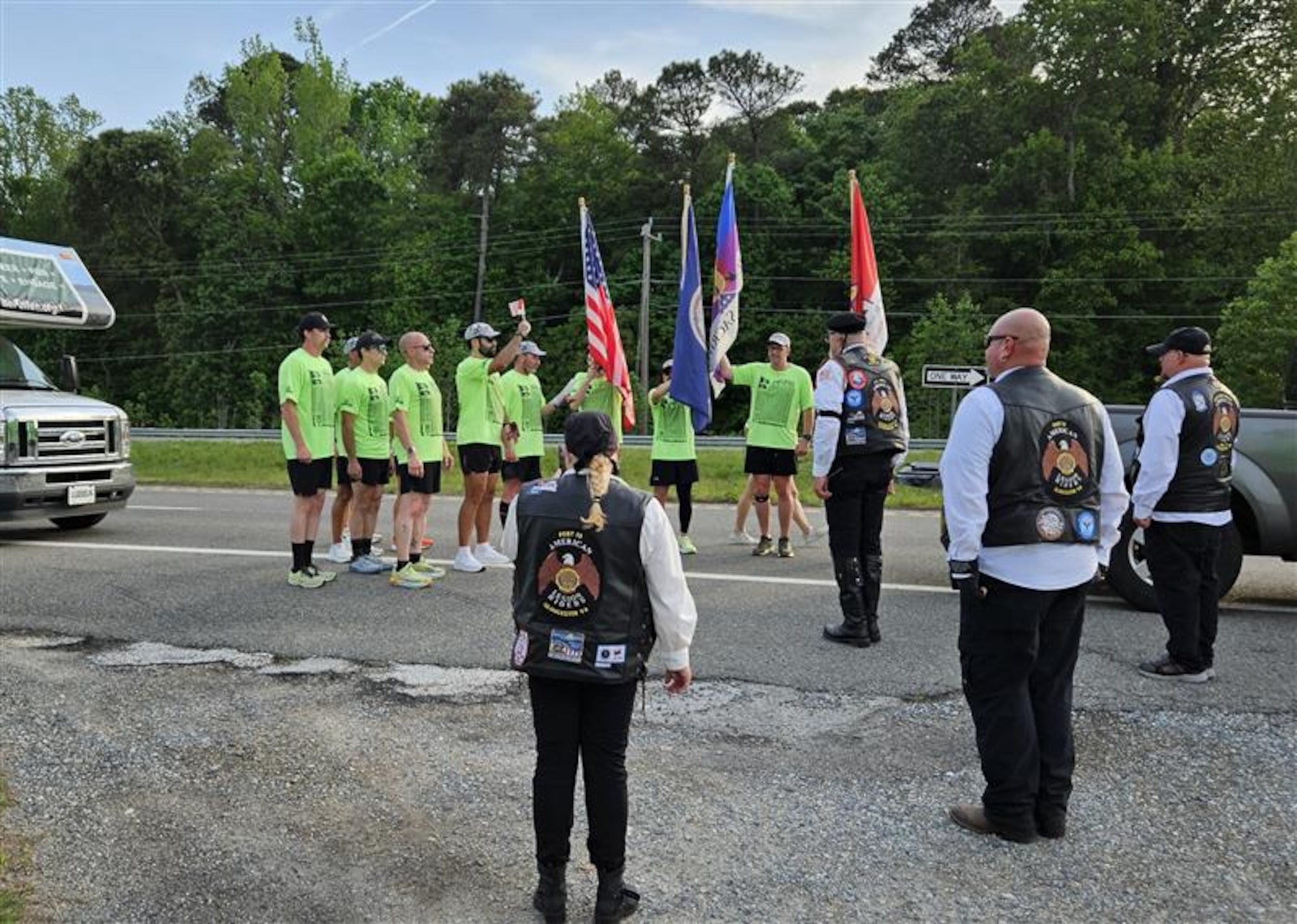 Runners stand at attention before flags. (U.S. Air Force photo by Airman 1st Class Skylar Ellis)