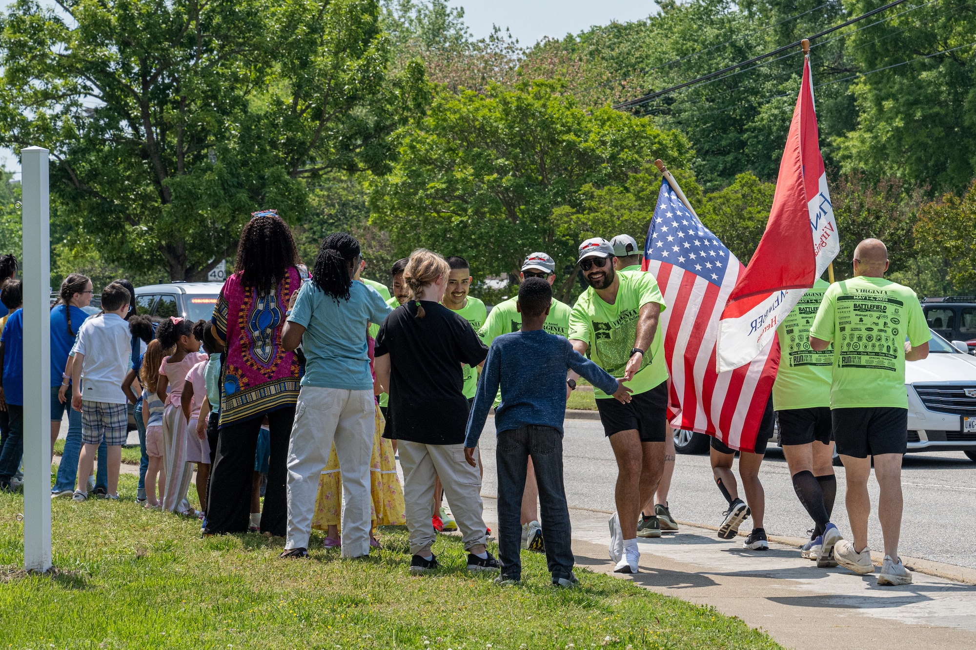 Runners high five children. (U.S. Air Force photo by Airman 1st Class Skylar Ellis)