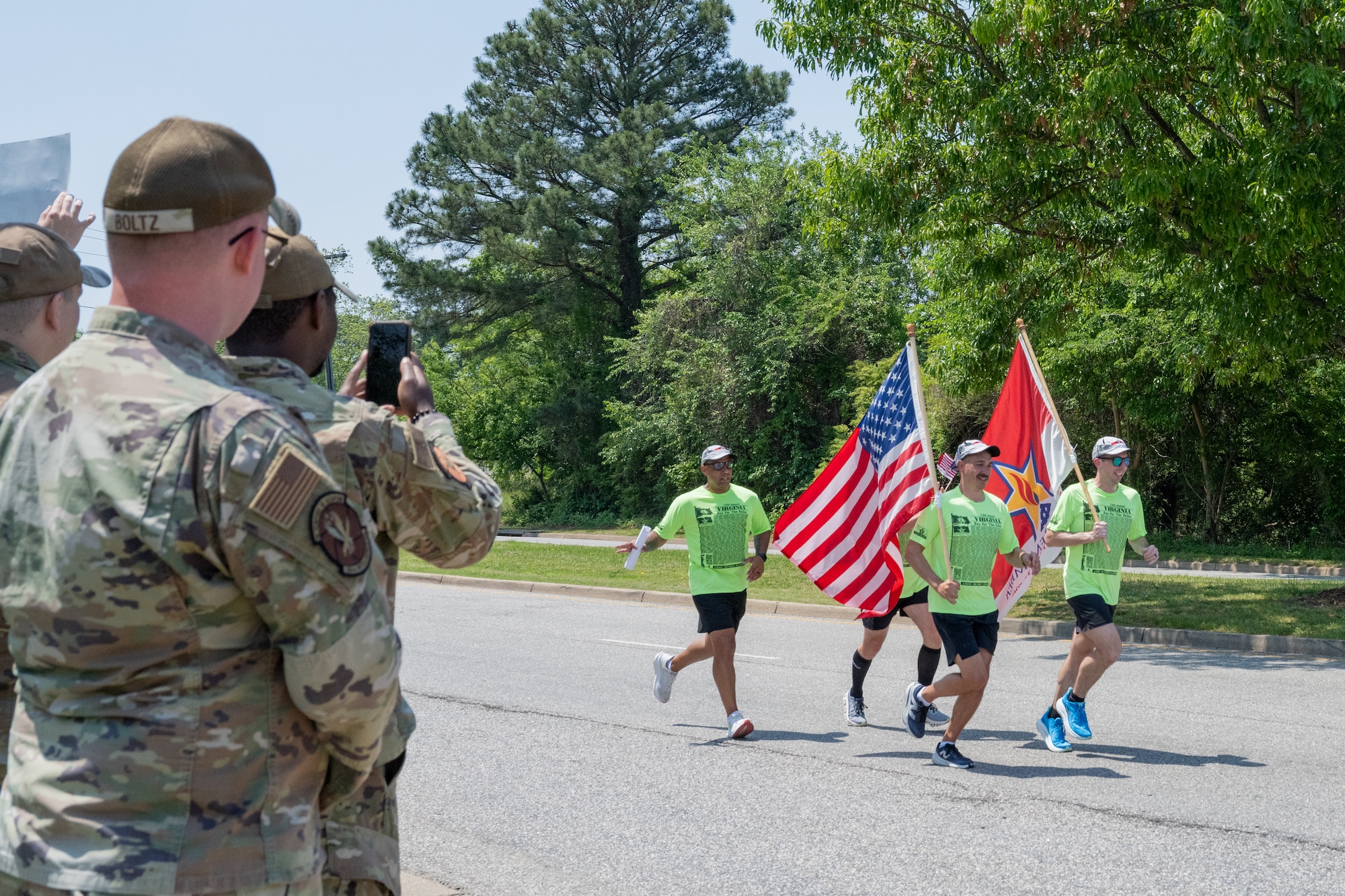 Airman takes photo of people running. (U.S. Air Force photo by Senior Airman Abigayl Salyer)