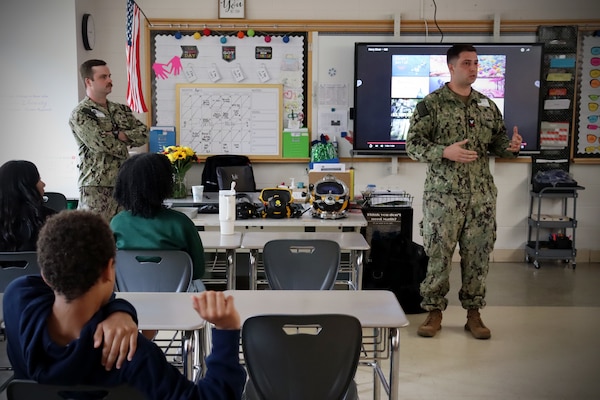 NORWICH, Conn. (May 2, 2025) Navy Diver 1st Class Connor Houtchens and Navy Diver 1st Class Cameron Duffy, from Naval Submarine Medical Research Laboratory (NSMRL), present on Navy Diving to students during the Kelly STEAM [Science, Technology, Engineering, Art, and Math] Magnet Middle School career day. Volunteers engaged with sixth, seventh, and eighth grade students, speaking on the impacts that Navy Medicine has on force health and readiness. Community events such as career days expose students to career paths they otherwise may not know about, sparking interest in medicine and STEM careers. NSMRL, part of Navy Medicine Research & Development and based out of Groton, Connecticut, sustains the readiness and superiority of U.S. undersea warfighters through innovative health and performance research and works to lead the world in delivering science solutions to ensure undersea warrior dominance. For 250 years, Navy Medicine, represented by more than 44,000 highly-trained military and civilian healthcare professionals, has delivered quality healthcare and enduring expeditionary medical support to the warfighter on, below, and above the sea and ashore. (U.S. Navy photo by Emily Swedlund/released)