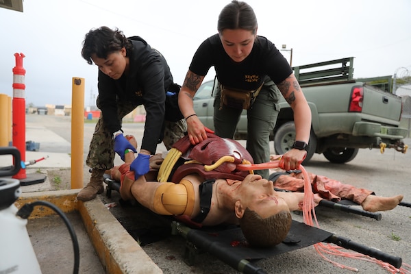 Hospital Corpsman 2nd Class Angela Solis (left) and Hospital Corpsman 3rd Class Abbigail Dunlap (right), moulage technicians with Naval Expeditionary Medicine Warfighter Development Center (NEMWDC), prepares a high-fidelity surgical manikin by loading simulated organs into the chest and putting on a cut suit during an Expeditionary Resuscitative Surgical System course at NEMWDC, Apr. 14. Solis expresses, “I believe realistic moulage plays a critical role in medical simulations because it helps bridge the gap between textbook knowledge and real-world application. It enhances the students’ ability to recognize injury patterns and apply appropriate treatment algorithm more intuitively.” (U.S. Navy photo by Petty Officer 2nd Class Moira Francine Esquivel)