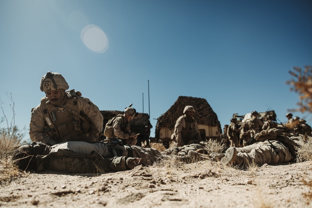 U.S. Navy Hospitalman 2nd Class Antonio Garcia, a Harlingen, Texas native, hospital corpsman with 3rd Battalion, 14th Marine Regiment, 4th Marine Division, provides medical attention to a simulated casualty during a Marine Air-Ground Task Force Warfighting Exercise at MCAGCC, Twentynine Palms, California, Feb. 20, 2025.  MWX is a comprehensive force-on-force training event designed to enhance the operational readiness and combat effectiveness of all MAGTF elements by simulating complex and dynamic battle scenarios while refining tactics. Service Level Training Exercise 1-25 is purpose built to increase readiness across Core Mission Essential Tasks, preparing composite task forces for force-on-force operations across a contested multi-domain distributed environment through modern training tools and data capture.  (U.S. Marine Corps photo by Lance Cpl. Richard PerezGarcia)