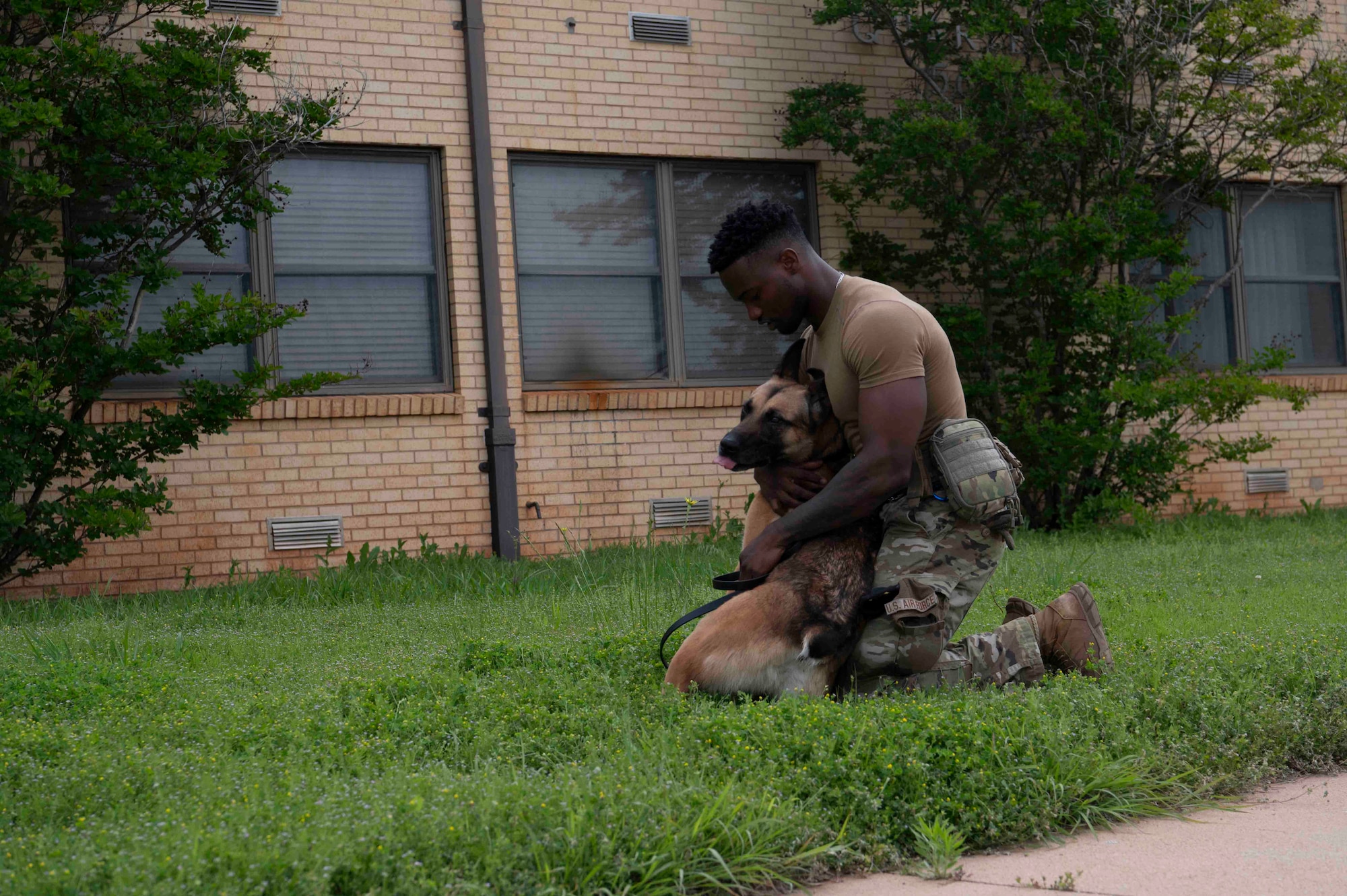 k9 handler hugs dog
