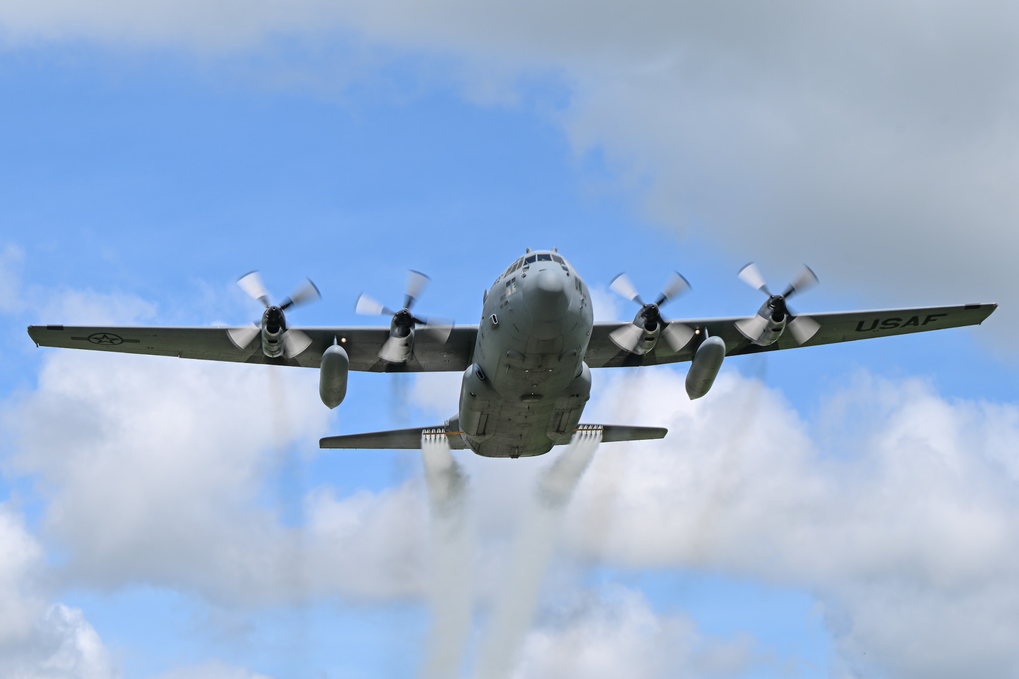 A 910th Airlift Wing C-130H Hercules aircraft, equipped with a training-only modular aerial spray system, flies near Youngstown Air Reserve Station, Ohio, May 7, 2025. The aircraft performed a larvicide application demonstration, using water, for a group of pest management specialists from across the Department of Defense attending an aerial spray application course.