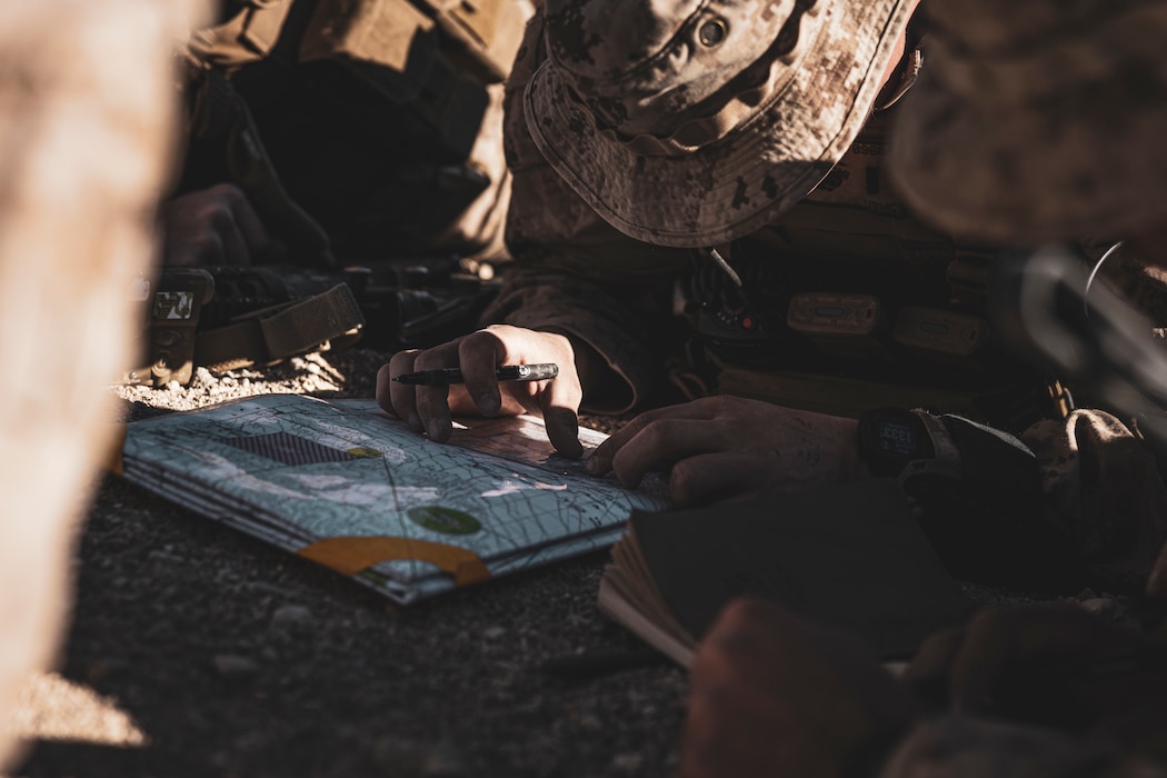 U.S. Marines with 5th Battalion, 14th Marine Regiment, 4th Marine Division, mark the impact of rounds during a Fire Support Coordination Exercise as part of Service Level Training Exercise 0-25 at Training Area Quackenbush, Marine Corps Air-Ground Combat Center, Twentynine Palms, California, Dec. 6, 2024. FSCEX is a live-fire training event integrating infantry battalion combat operations center functions, distributed artillery, mobile fire support teams, close air support assets, and electronic warfare support teams. SLTE 0-25 is designed to enhance readiness across core Mission Essential Tasks and prepare Marines for Force-on-Force operations.  (U.S. Marine Corps photo by Lance Cpl. Enge You)