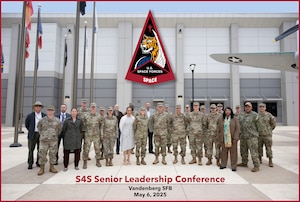 A group of Senior Space Force Guardians and civilians pose for a photo.