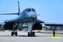U.S. Air Force Senior Airman Colby Delia, 9th Expeditionary Bomb Squadron crew chief, marshals a B-1B Lancer on a flight line during Bomber Task Force 25-2 at Misawa Air Base, Japan, May 3, 2025.