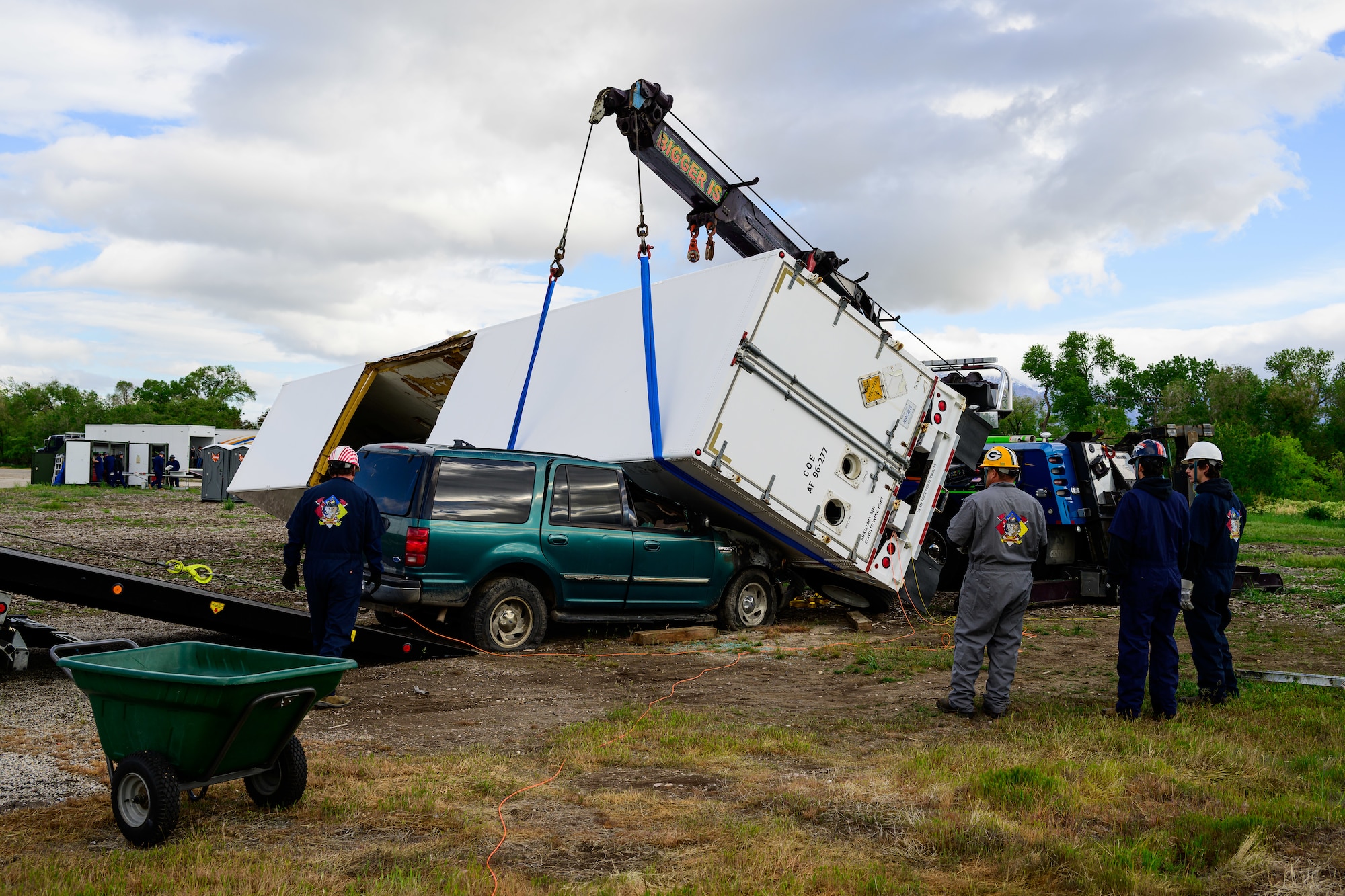 Members of the Missile Mishap Recovery Team lifts an overturned trailer off a vehicle during a training event in Ogden, Utah, May 5, 2025. With exception to the warhead, the MMRT responds to Minuteman III situations that fall out of the scope of tech data and standard procedures or pose significant hazards. The highly specialized team is the only one in the Air Force. (U.S. Air Force photo by R. Nial Bradshaw)