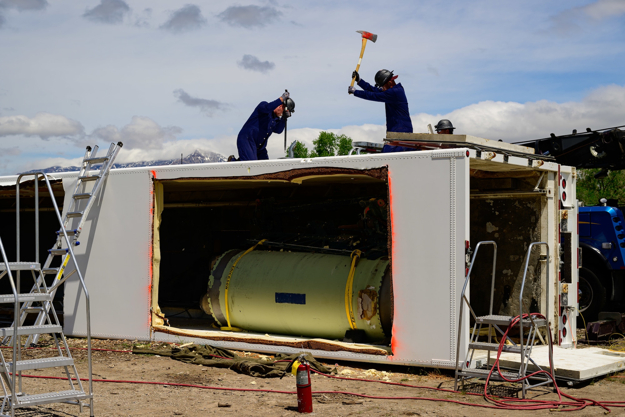 Members of the Missile Mishap Recovery Team cut into a trailer during a training event in Ogden, Utah, May 5, 2025. With exception to the warhead, the MMRT responds to Minuteman III situations that fall out of the scope of tech data and standard procedures or pose significant hazards. The highly specialized team is the only one in the Air Force. (U.S. Air Force photo by R. Nial Bradshaw)