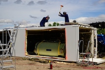 Members of the Missile Mishap Recovery Team cut into a trailer during a training event in Ogden, Utah, May 5, 2025. With exception to the warhead, the MMRT responds to Minuteman III situations that fall out of the scope of tech data and standard procedures or pose significant hazards. The highly specialized team is the only one in the Air Force. (U.S. Air Force photo by R. Nial Bradshaw)