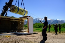Members of the Missile Mishap Recovery Team lift a Minuteman III motor during a training event in Ogden, Utah, May 5, 2025. With exception to the warhead, the MMRT responds to Minuteman III situations that fall out of the scope of tech data and standard procedures or pose significant hazards. The highly specialized team is the only one in the Air Force. (U.S. Air Force photo by R. Nial Bradshaw)