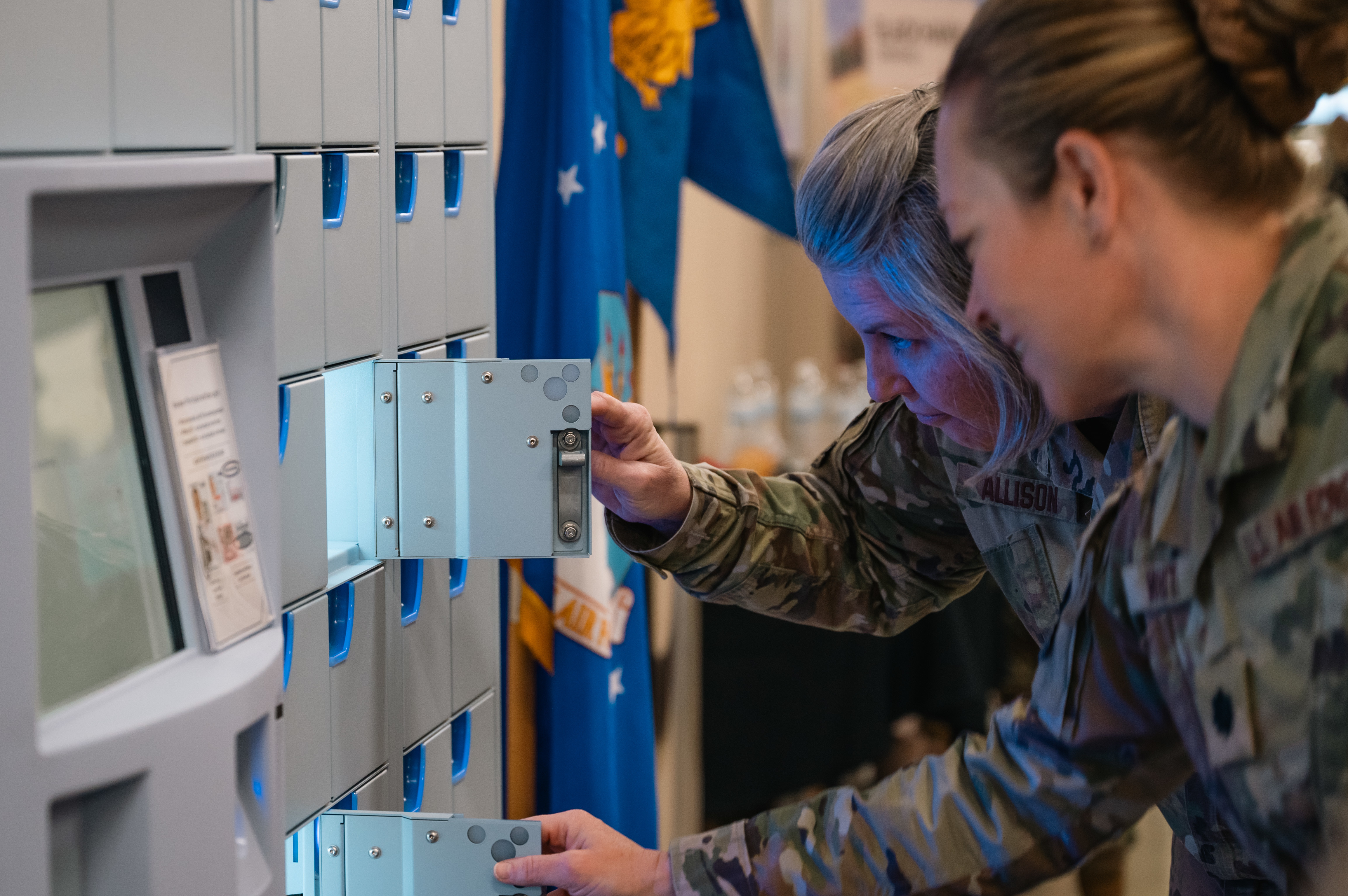 Service members from Buckley Space Force Base inspect a ScriptCenter kiosk during a ribbon cutting ceremony on May 6, 2025. The ScriptCenter is a free, no-contact kiosk where prescriptions, once filled by the pharmacy, are securely stored for convenient pickup. (U.S. Space Force photo by Staff Sgt. Danielle McBride)